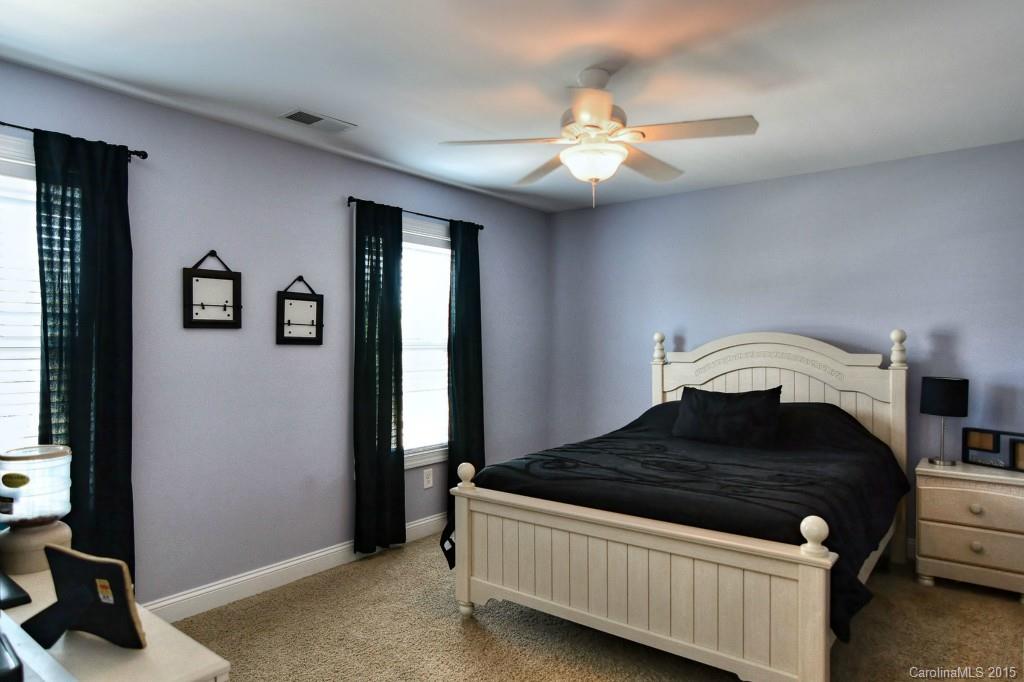 1628 Ridgehaven Road Waxhaw, NC 28173 - Photo 16 of 24 a bedroom with a bed and a chandelier