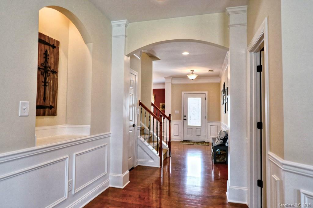 1628 Ridgehaven Road Waxhaw, NC 28173 - Photo 3 of 24 a view of a hallway with wooden floor and staircase