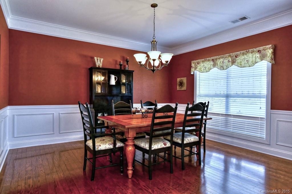 1628 Ridgehaven Road Waxhaw, NC 28173 - Photo 4 of 24 a dining room with furniture a chandelier and wooden floor