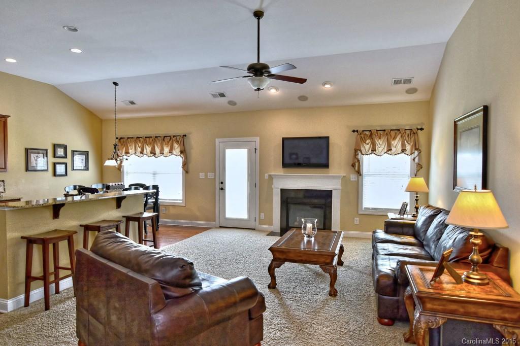 1628 Ridgehaven Road Waxhaw, NC 28173 - Photo 5 of 24 a living room with furniture a fireplace and a flat screen tv