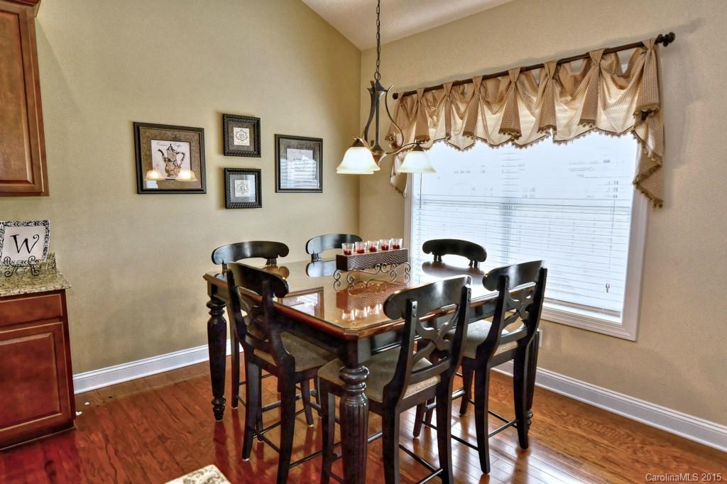 1628 Ridgehaven Road Waxhaw, NC 28173 - Photo 10 of 24 a view of a dining room with furniture and wooden floor