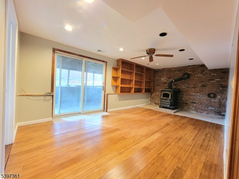 10 Richards Road Hopatcong, NJ 07843 - Photo 13 of 18 a view of empty room with a fireplace and wooden floor