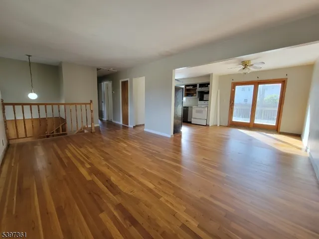 a view of a room with wooden floor and a window