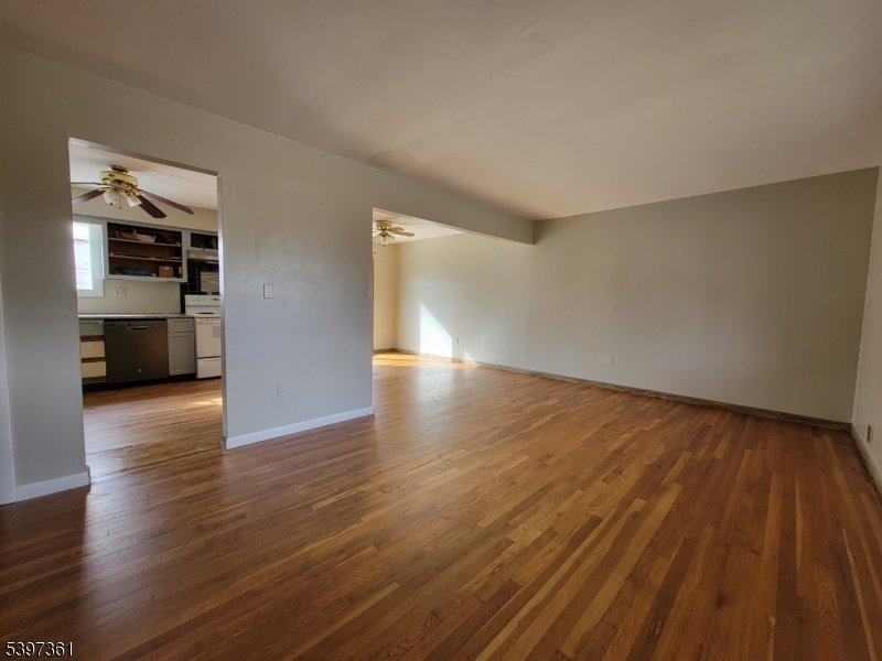 10 Richards Road Hopatcong, NJ 07843 - Photo 5 of 18 a view of empty room with wooden floor and kitchen