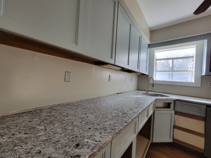 10 Richards Road Hopatcong, NJ 07843 - Photo 7 of 18 a kitchen with granite countertop a sink and a stove top oven