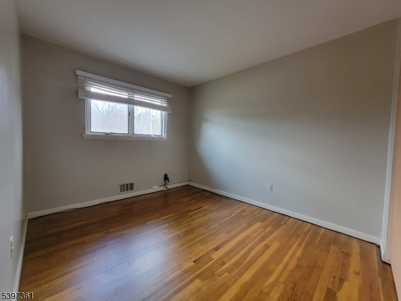 10 Richards Road Hopatcong, NJ 07843 - Photo 8 of 18 an empty room with wooden floor and windows