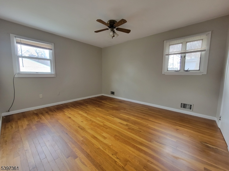 10 Richards Road Hopatcong, NJ 07843 - Photo 9 of 18 a view of a room with wooden floor and a ceiling fan