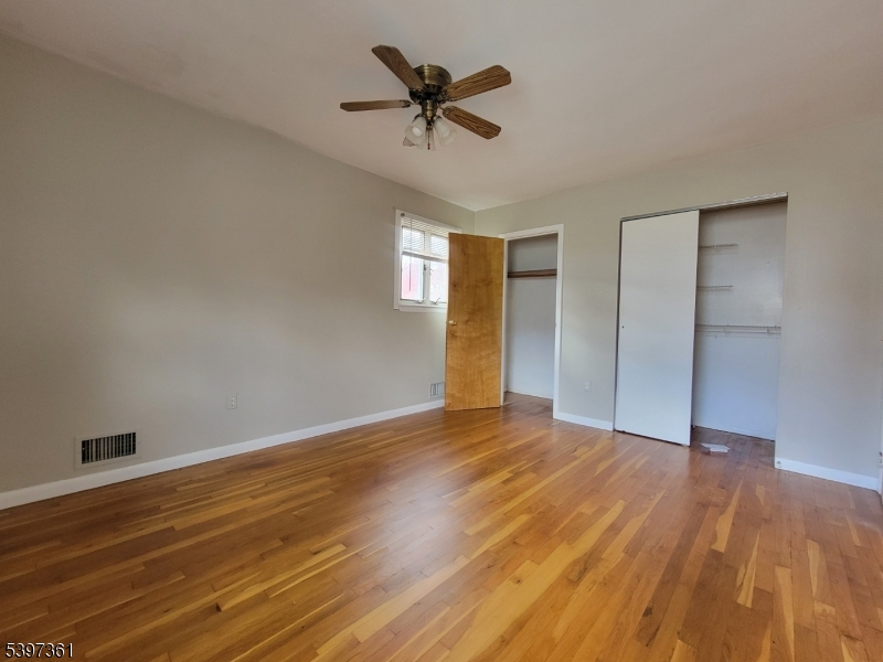 10 Richards Road Hopatcong, NJ 07843 - Photo 10 of 18 a view of an empty room with a window and wooden floor