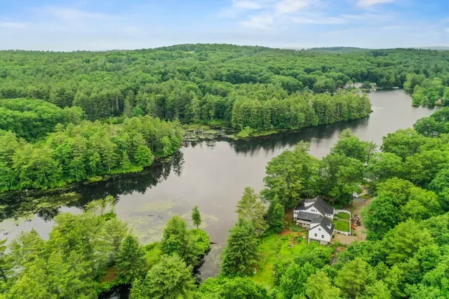an aerial view of a houses with outdoor space and lake view