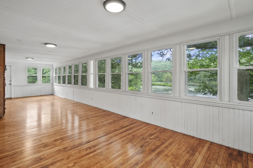3 Cranberry Meadow Shore Road Charlton, MA 01507 - Photo 11 of 39 an empty room with wooden floor and windows