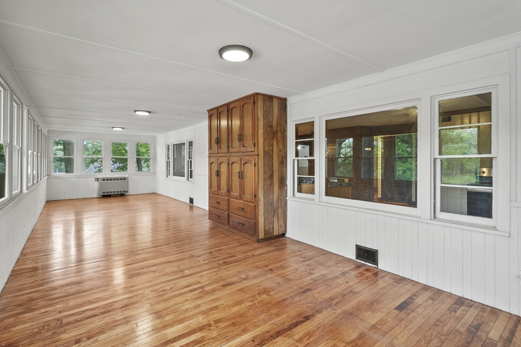 3 Cranberry Meadow Shore Road Charlton, MA 01507 - Photo 12 of 39 a view of empty room with wooden floor and windows