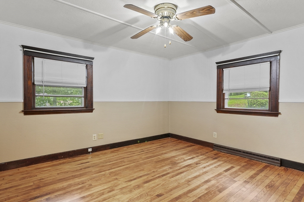 3 Cranberry Meadow Shore Road Charlton, MA 01507 - Photo 13 of 39 a view of an empty room with wooden floor and a window