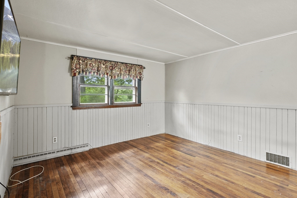 3 Cranberry Meadow Shore Road Charlton, MA 01507 - Photo 21 of 39 an empty room with wooden floor and windows