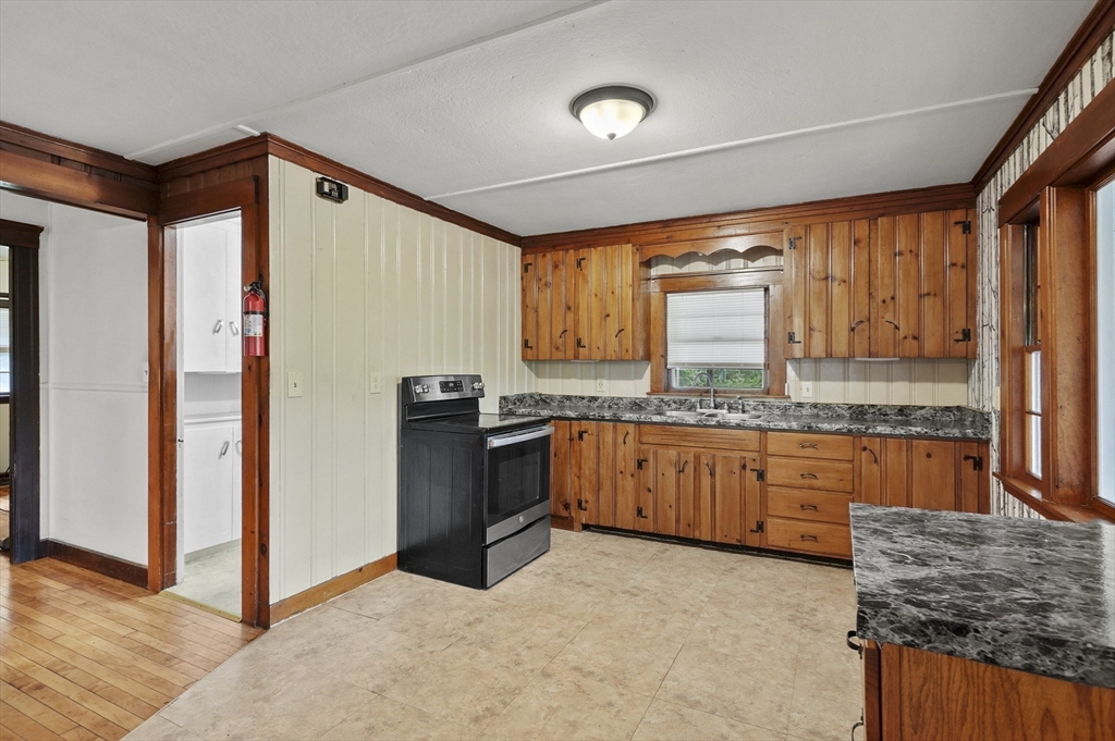 3 Cranberry Meadow Shore Road Charlton, MA 01507 - Photo 7 of 39 a kitchen with granite countertop a sink stove and refrigerator