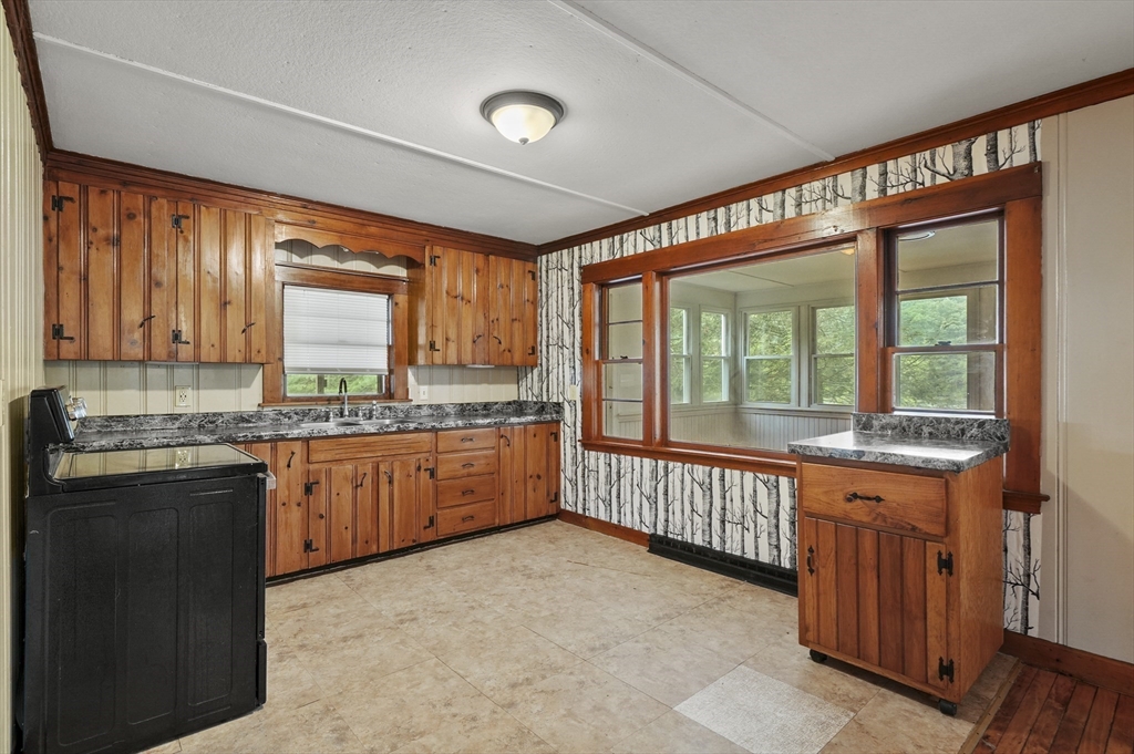3 Cranberry Meadow Shore Road Charlton, MA 01507 - Photo 8 of 39 a large kitchen with granite countertop a sink and cabinets
