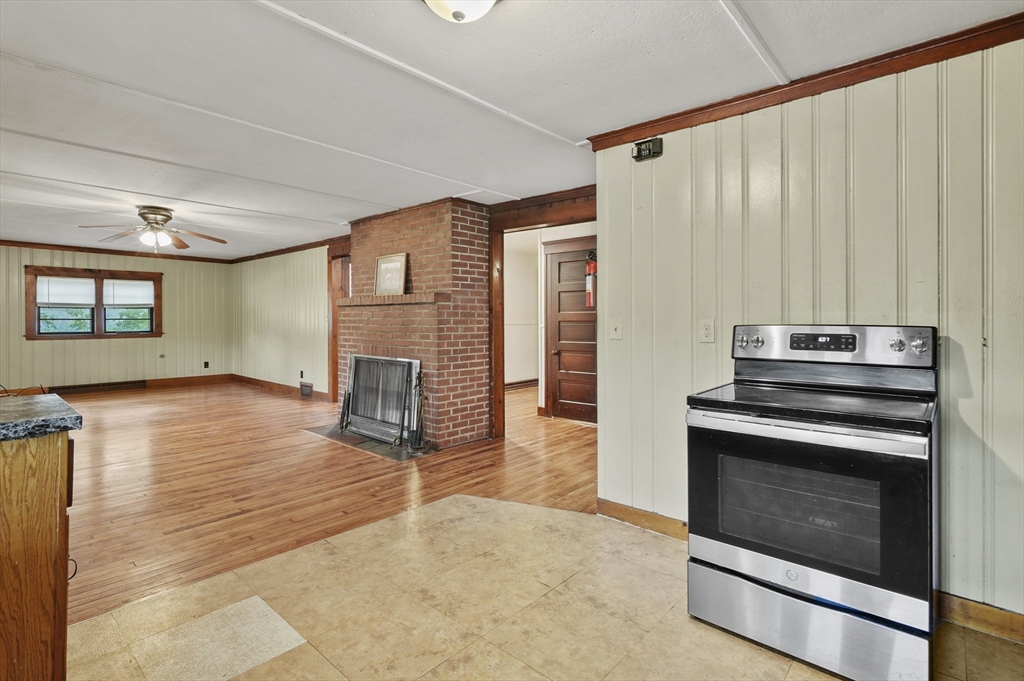 3 Cranberry Meadow Shore Road Charlton, MA 01507 - Photo 9 of 39 a kitchen with a stove and a fireplace