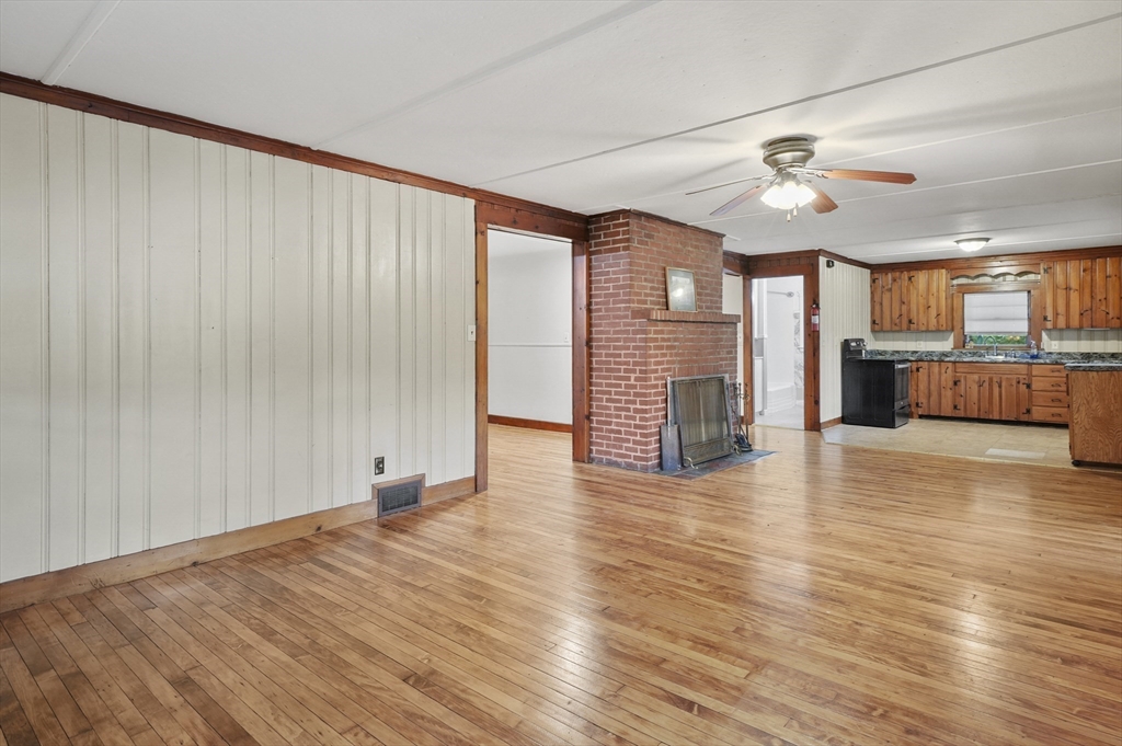 3 Cranberry Meadow Shore Road Charlton, MA 01507 - Photo 10 of 39 an empty room with wooden floor and windows