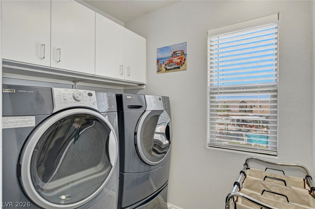 48 Jasmine Point Street Henderson, NV 89074 - Photo 50 of 62 Maximize convenience with this dedicated laundry area, featuring ample cabinetry and a practical window.