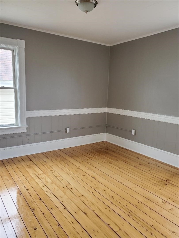 762 Globe Street, Unit 2 Fall River, MA 02724 - Photo 12 of 20 a view of empty room with wooden floor and fan