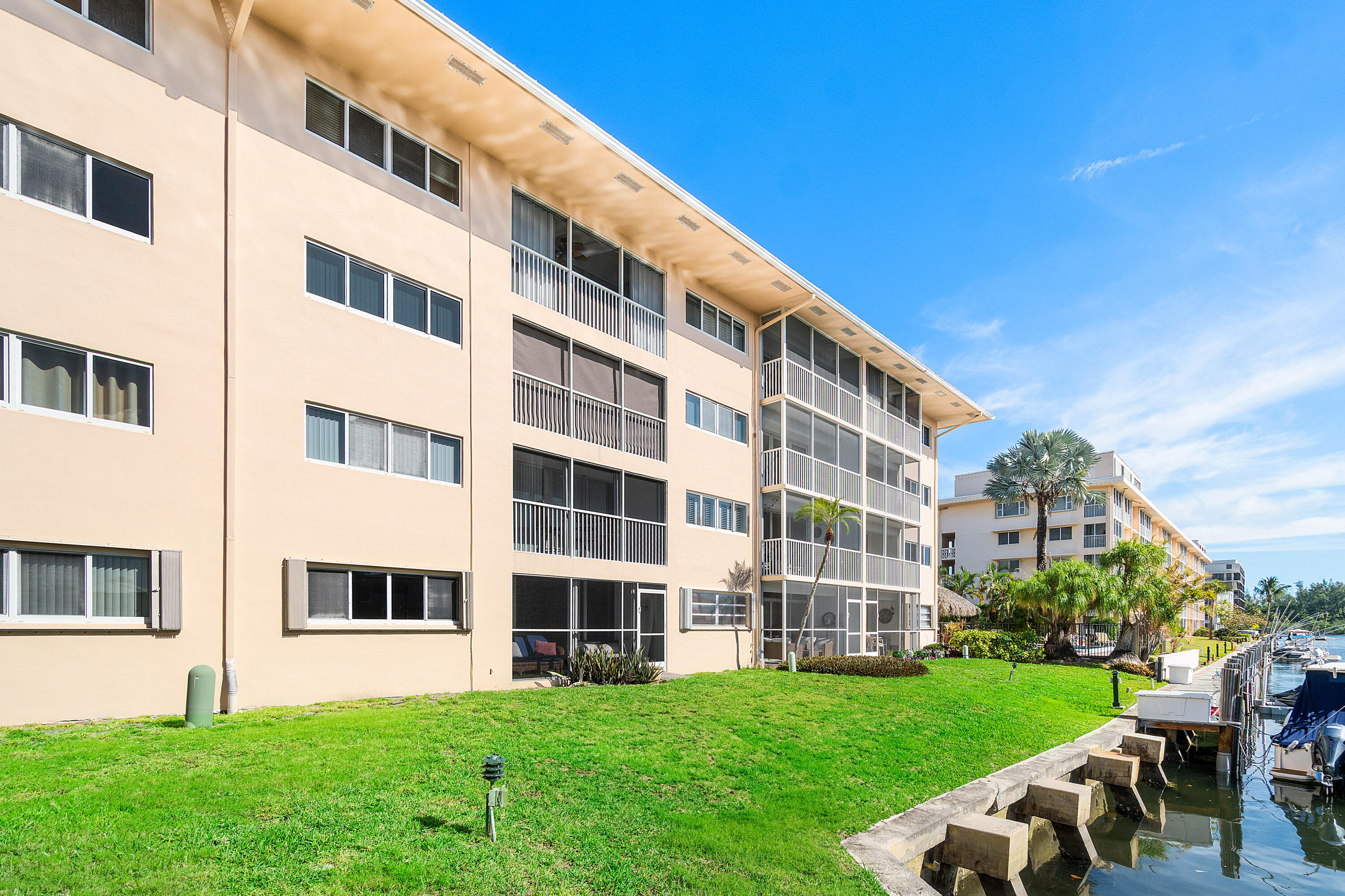 698 Northeast Spanish River Boulevard, Unit 140 Boca Raton, FL 33431 - Photo 12 of 21 a view of a building with a yard