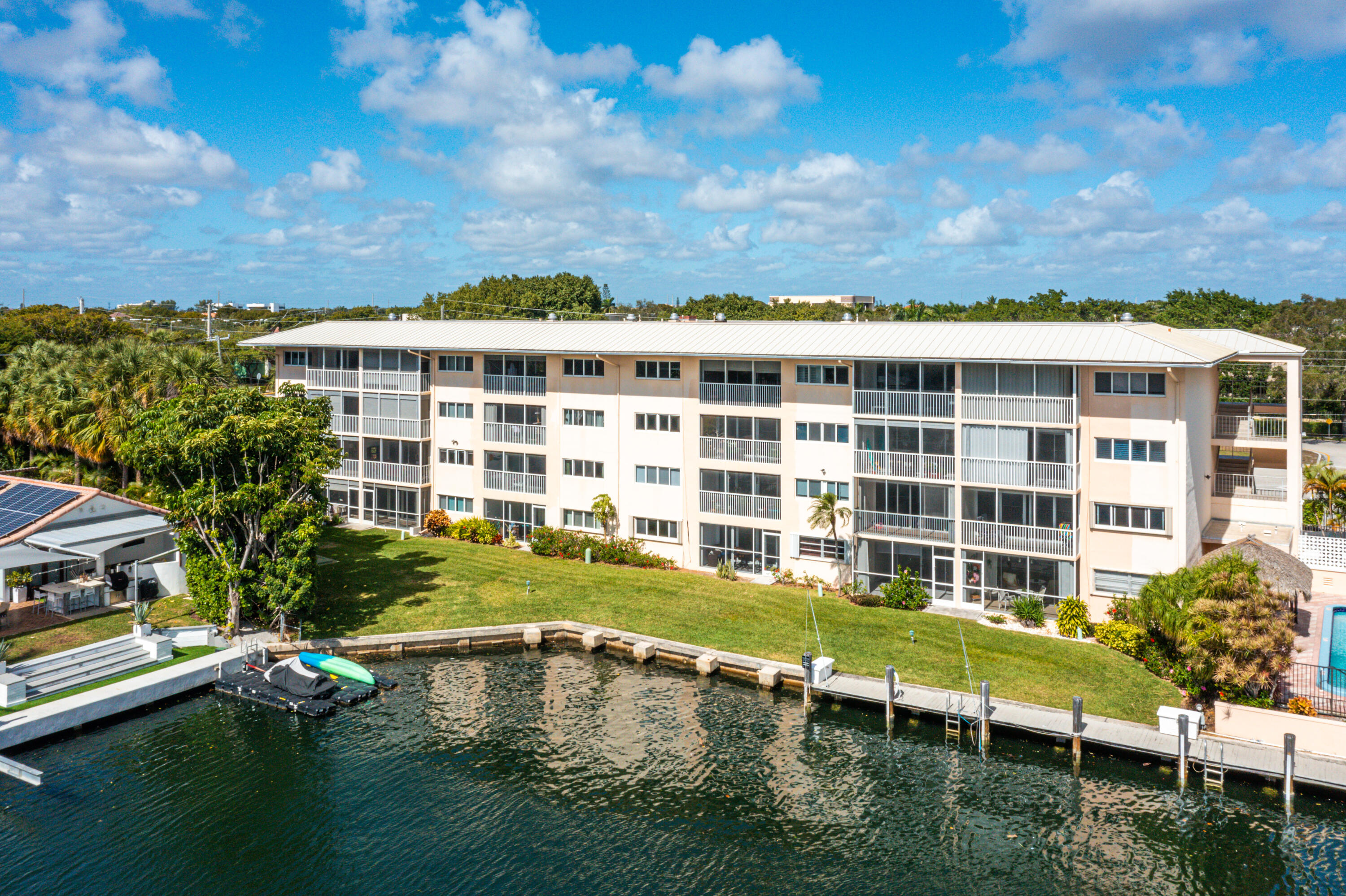 698 Northeast Spanish River Boulevard, Unit 140 Boca Raton, FL 33431 - Photo 15 of 21 a view of a swimming pool with outdoor seating