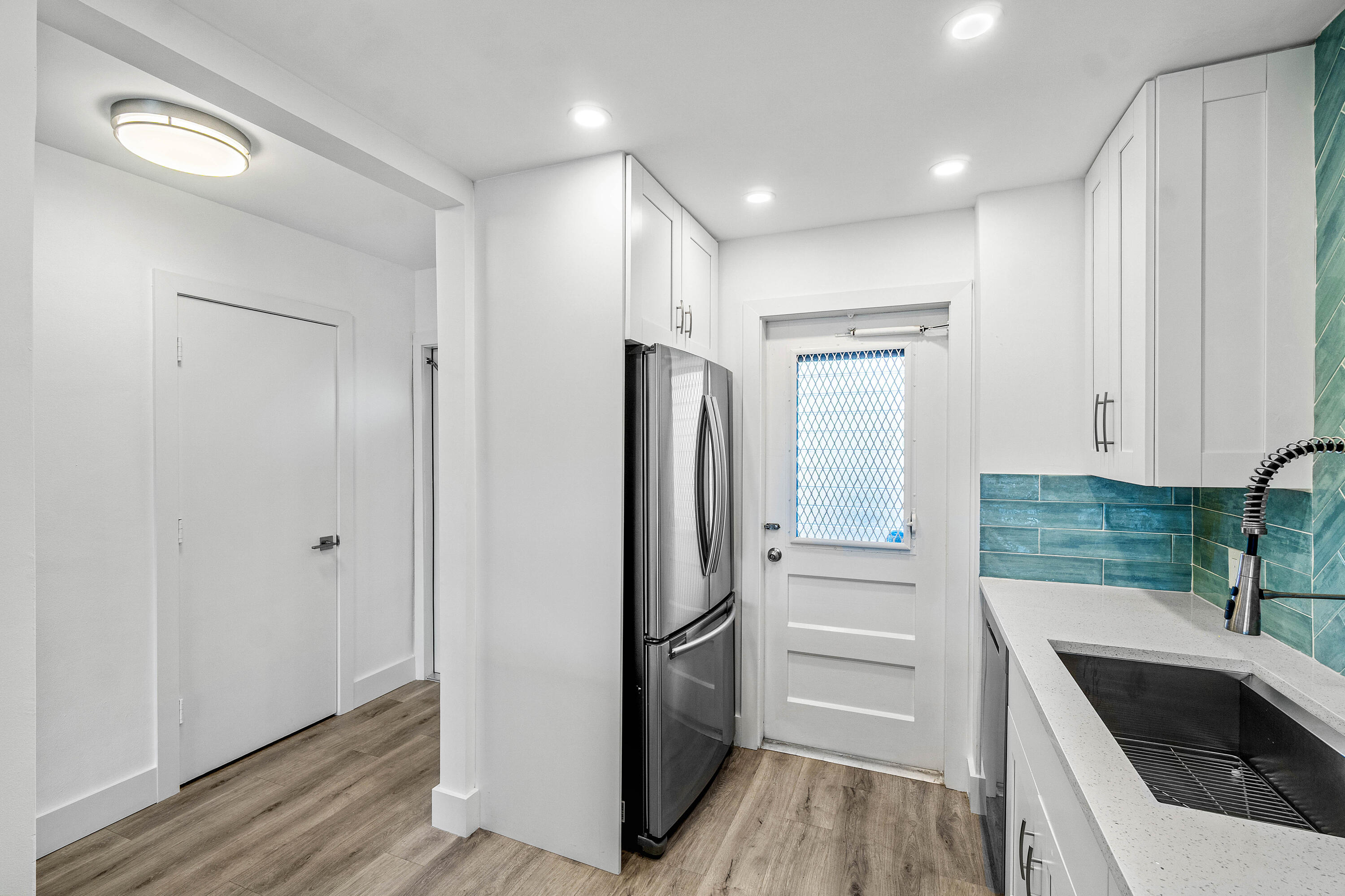 698 Northeast Spanish River Boulevard, Unit 140 Boca Raton, FL 33431 - Photo 4 of 21 a kitchen with a refrigerator sink and cabinets