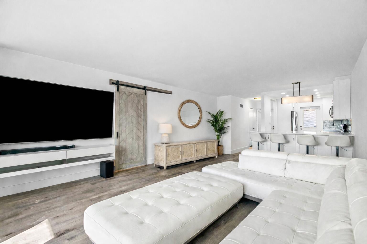 698 Northeast Spanish River Boulevard, Unit 140 Boca Raton, FL 33431 - Photo 6 of 21 a living room with furniture and a flat screen tv