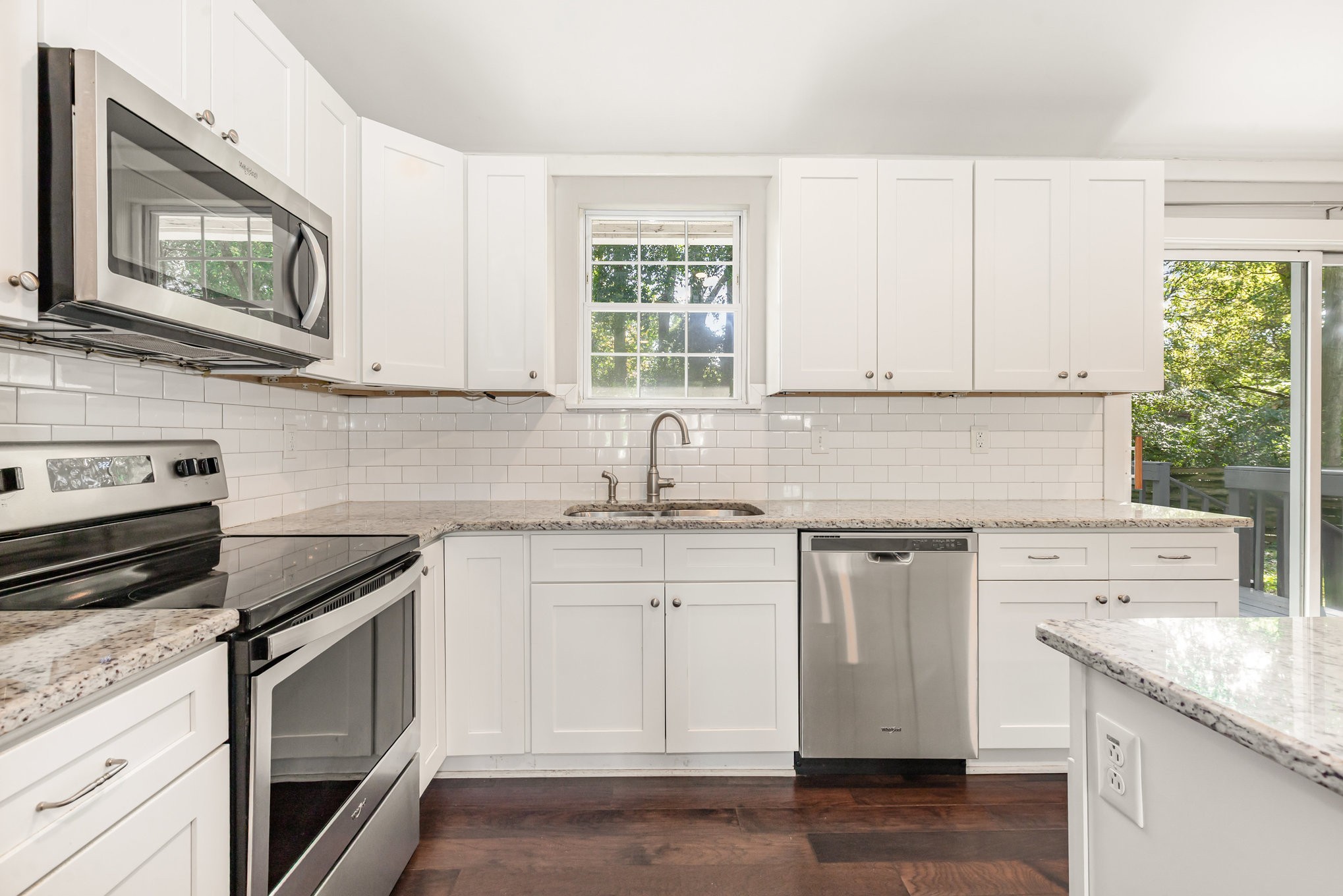 118 Brevet Drive Franklin, TN 37064 - Photo 9 of 18 a kitchen with granite countertop white cabinets and white appliances