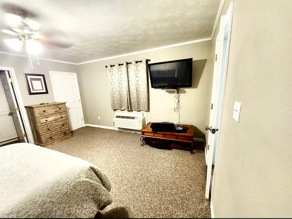 a bedroom with a bed and a mirror