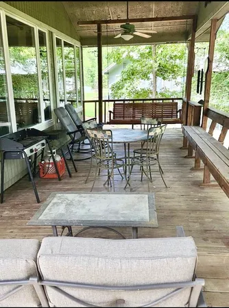 a roof deck with table and chairs and wooden floor