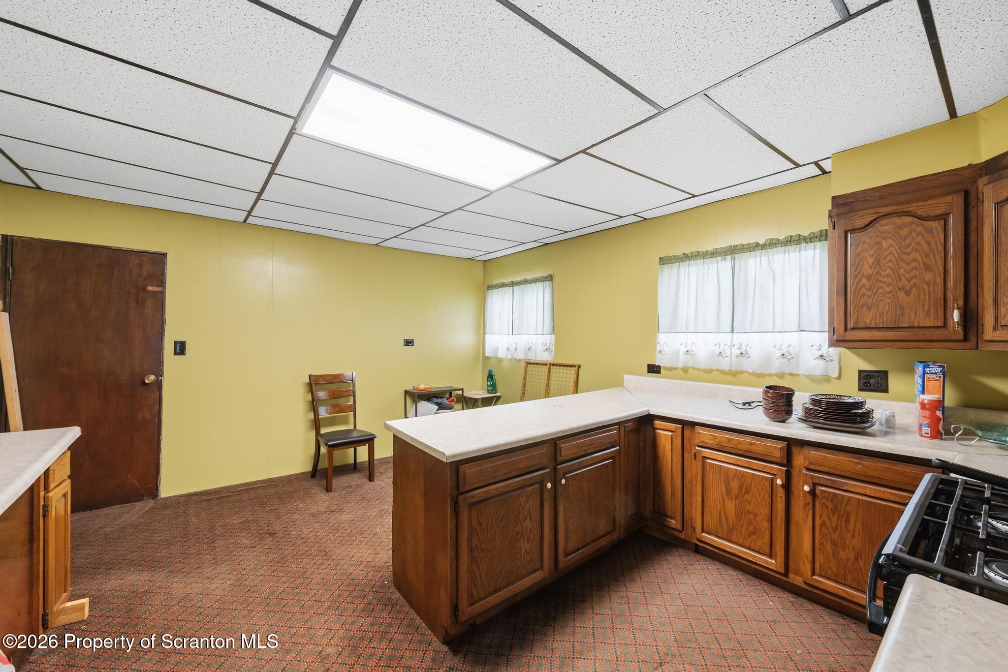 810 Pine Street Mayfield, PA 18433 - Photo 20 of 37 a kitchen with a sink a stove cabinets and wooden floor