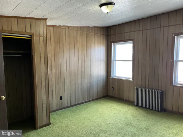 a view of an empty room with closet area