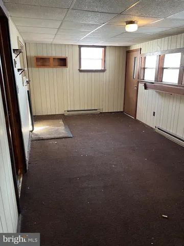 a view of empty room with wooden floor and cabinet