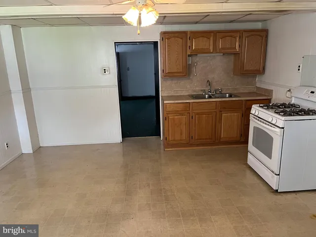 a kitchen with a stove and a refrigerator