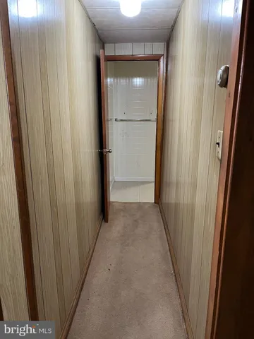 an empty room with closet and a chandelier fan