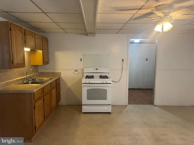 a kitchen with a stove sink and a refrigerator