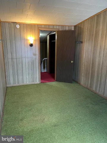 an empty room with wooden floor and closet