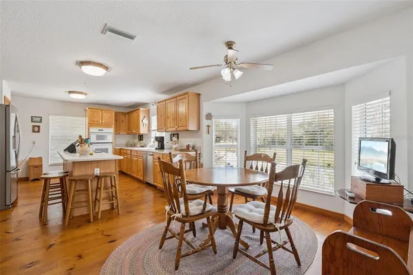 a view of a dining room with furniture window and wooden floor
