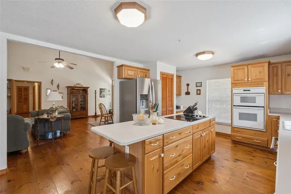 a large white kitchen with a large window