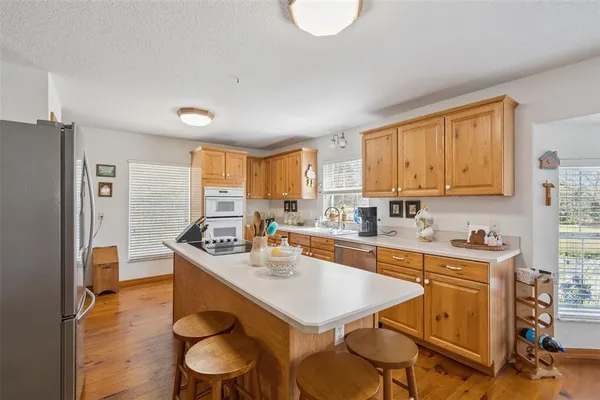 a kitchen with a stove a sink and a refrigerator