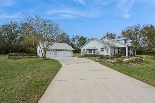 a view of house with outdoor space and garden