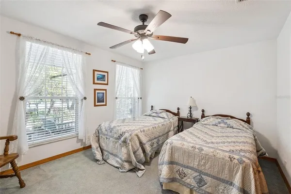 a bedroom with two beds and a window