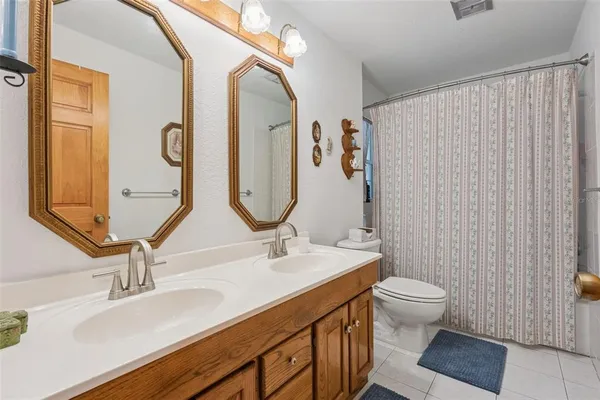 a bathroom with a bathtub shower and toilet