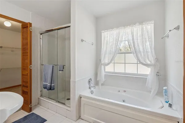 a bathroom with a bathtub and a shower