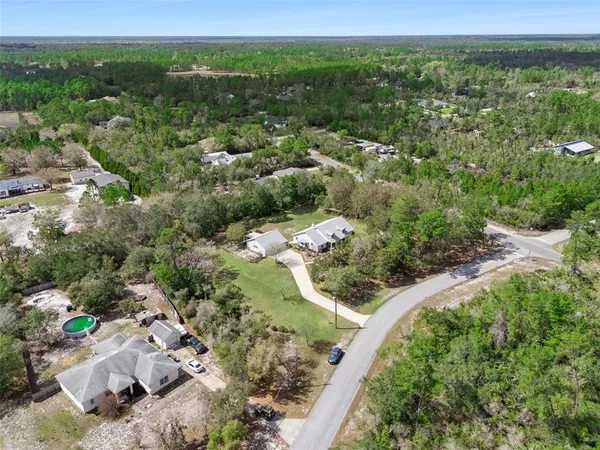 an aerial view of a house with outdoor space
