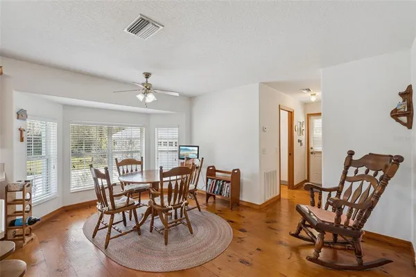 a dining room with furniture a rug and wooden floor