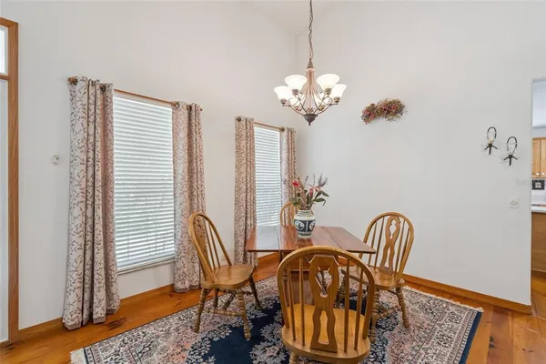 a view of a dining room with furniture wooden floor and chandelier
