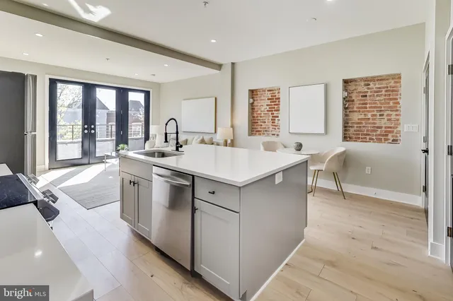 a kitchen with a sink stove and cabinets