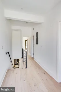 a view of a room with wooden floor and stairs