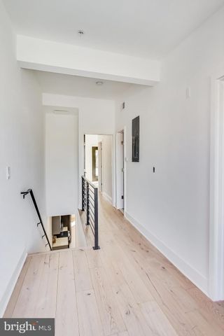 a view of a room with wooden floor and stairs